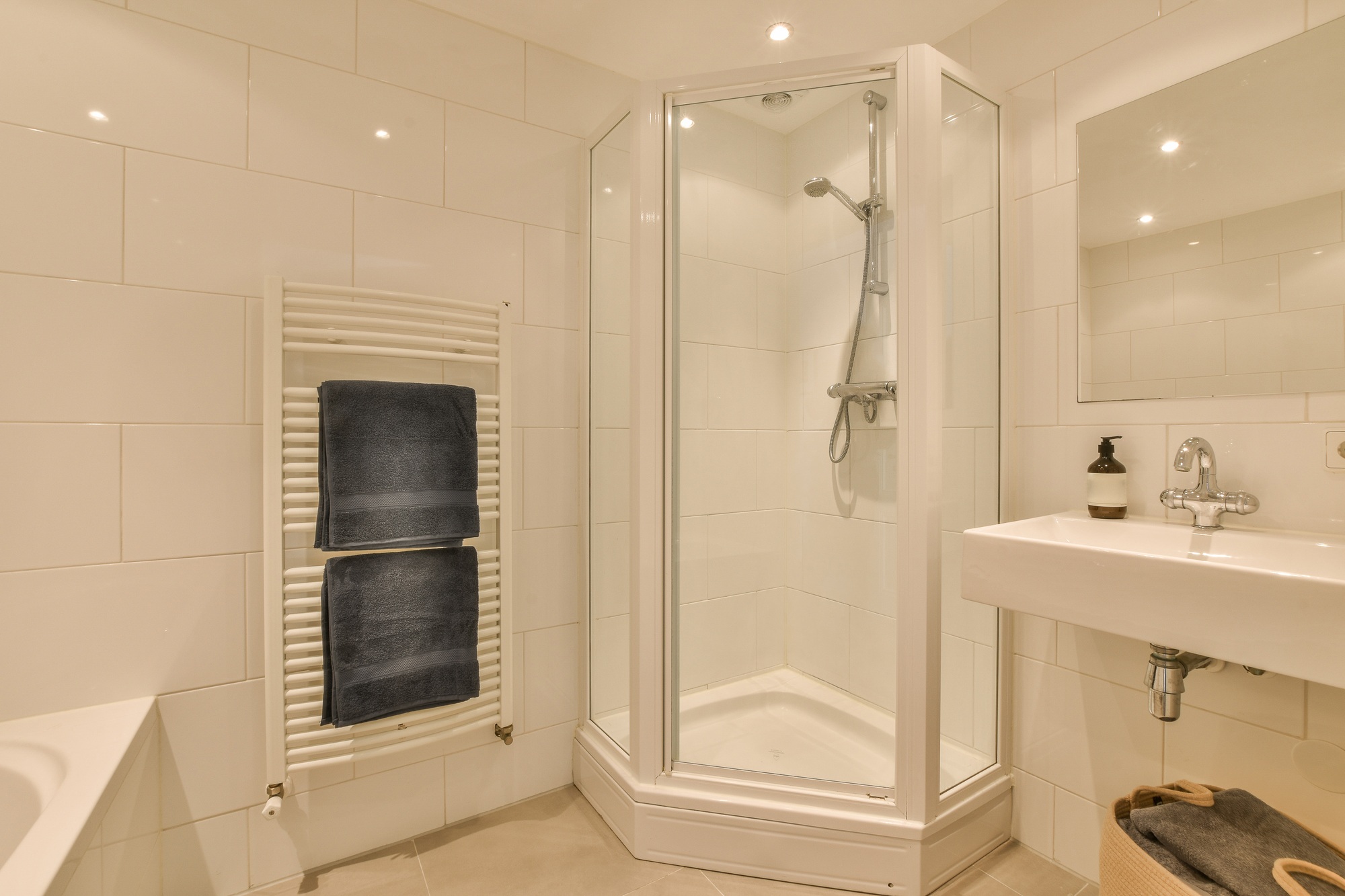 Sinks and bathtub near shower cabin
